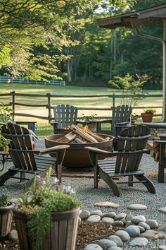 an outdoor fire pit surrounded by chairs and tables in the middle of a gravel area