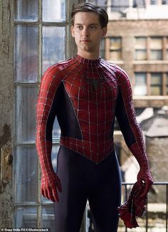 the amazing spider - man is standing in front of an open window with his hands on his hips