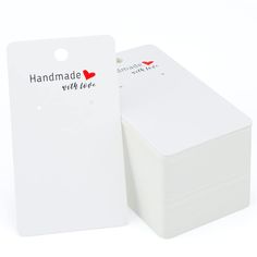 a stack of white cards with red hearts and the words handmade wild love written on them