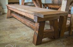 a wooden bench sitting in the middle of a room