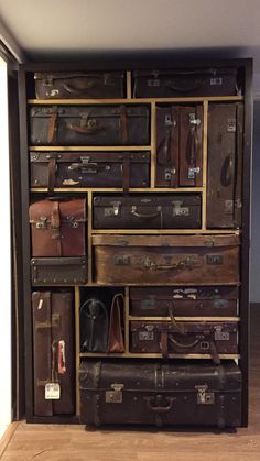 an assortment of suitcases are stacked on top of each other in a storage area