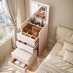 the drawers are open on top of each other in front of a bed and window