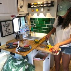 the woman is preparing food in the kitchen