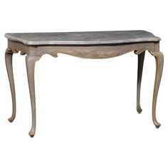 an antique console table with marble top