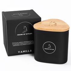 a black candle with a wooden lid next to a box that says house of styles