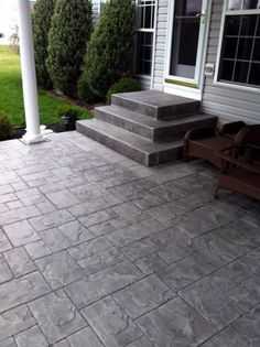 an outdoor patio with steps leading up to the front door