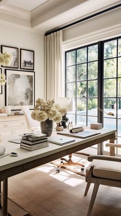 a living room filled with lots of furniture and flowers on top of a wooden table