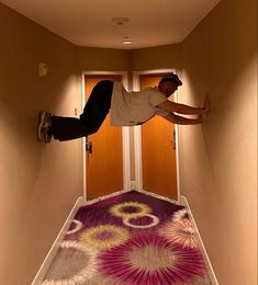 a man flying through the air while riding a skateboard on top of a carpet