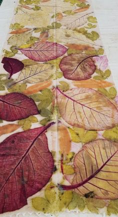 a table runner with colorful leaves on it