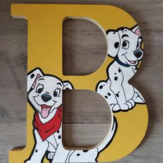 a wooden letter with a dalmatian dog on it's front and side