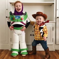 two children dressed up as buzz lightyear and toy story book characters, standing next to each other