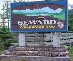 there is a sign that says seward welcomes you