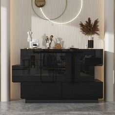 a black cabinet in front of a wall with a circular mirror above it and plants on top