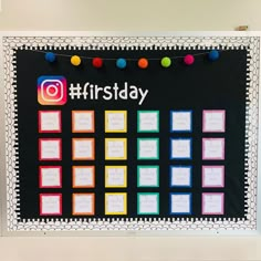 a bulletin board with the words first day written on it and colorful balls hanging from strings