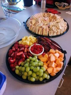 two platters filled with different types of fruit