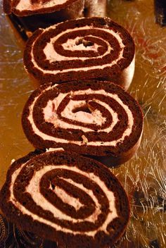 three chocolate rolls sitting on top of a counter