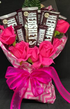 a bouquet of pink roses and chocolate bars