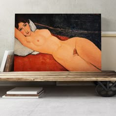 a painting is sitting on top of a wooden bench in front of a white wall