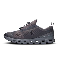 the on cloud running shoe is grey and has laces at the top, along with an insulated rubber sole