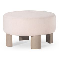 a white ottoman sitting on top of a wooden table