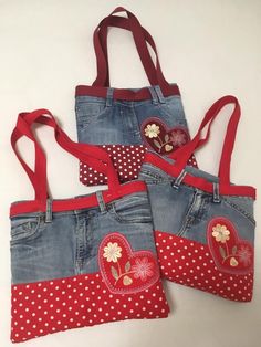 three purses with red and white polka dots, one has a heart on it