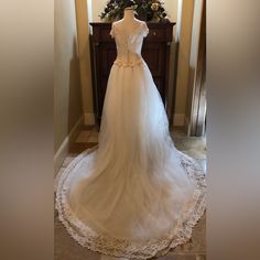 a wedding dress on display in front of a mirror