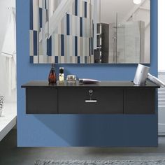 a bathroom with blue walls and a mirror on the wall next to a vanity table