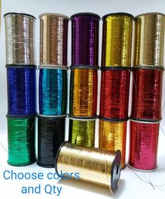 spools of different colors and sizes of tinned wire on a white background