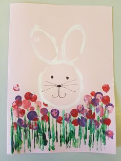 an art project for kids with flowers and a bunny's face painted on it