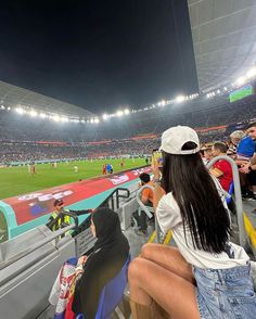 people are sitting in the stands at a soccer game