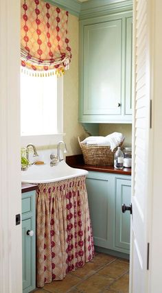 an open door leading to a kitchen with sink and utensils on the counter