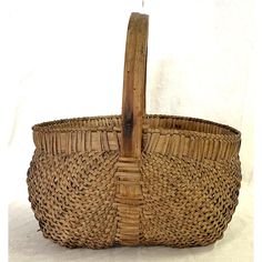 a wicker basket with a wooden handle