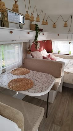 the inside of a camper with two beds and a couch