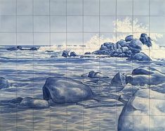 a tile wall with rocks in the water and waves crashing on it's surface