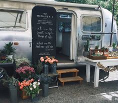 an old camper is decorated with flowers and plants