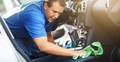 a man cleaning the inside of a car