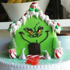 a gingerbread house decorated with candy canes and candies on top of a counter