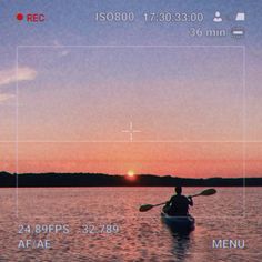 a person in a kayak on the water at sunset