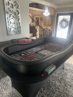 an inflatable pool table with games on the top and two dice boards at the bottom