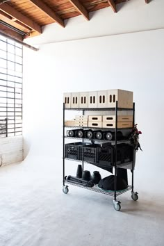 a shelf filled with musical equipment in a room next to a window on the wall