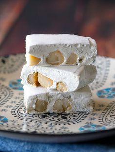 three pieces of food sitting on top of a blue and white plate with an ornate design