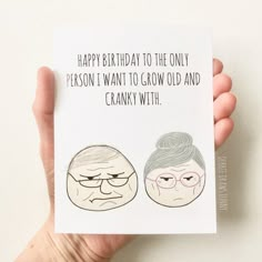 a person holding up a card with an image of two older people on it that says happy birthday to the only person i want to grow old and cranky