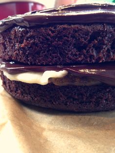 a chocolate sandwich with white frosting on top