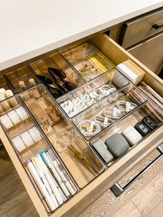 the drawers are organized with various items such as pens, pencils and other office supplies