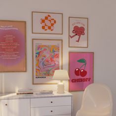 a white dresser sitting next to a wall covered in pictures and art hanging on it's side