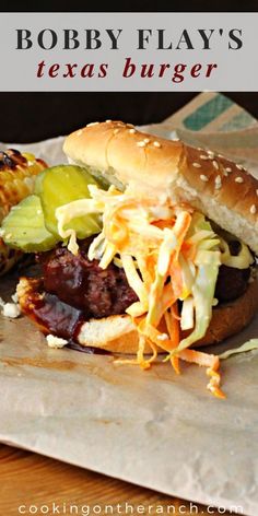 there is a hamburger with coleslaw and pickles on it