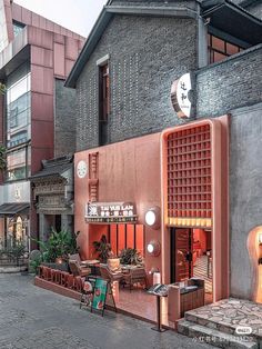 an outdoor cafe with tables and chairs on the sidewalk