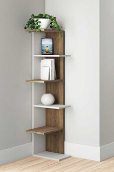 a corner shelf with some books and plants on it in the corner of a room