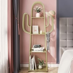 a room with pink walls and a gold shelving unit in the corner next to a bed