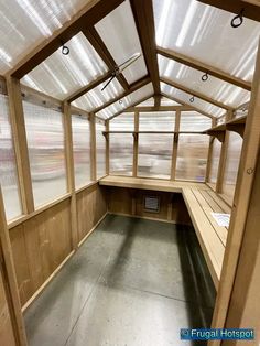 the inside of a wooden building with lots of windows